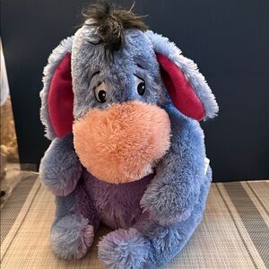 Disney Store Eeyore plush toy with a removable attached tail